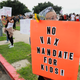 Anti-vaccine protesters stage a protest outside of the San Diego Unified School District office to protest a forced vaccination mandate for students on September 28, 2021 in San Diego, California.